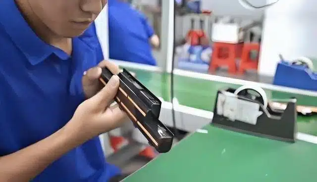 professional technician performing quality inspection on OEM laptop batteries at Balder Power factory for bulk orders.